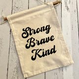 Strong, brave, kind canvas wall hanging
