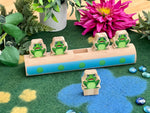 Five frogs on a log