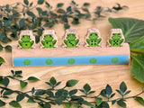 Five frogs on a log