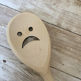 Sad face wooden spoon