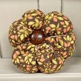 Handmade cotton pumpkin - brown background with autumn leaves