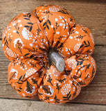 Handmade cotton pumpkin - bright orange background with black and white leaf design