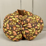 Handmade cotton pumpkin - brown background with autumn leaves