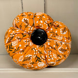 Handmade cotton pumpkin - bright orange background with black and white leaf design