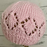 Pink beanie hat with patterned edge